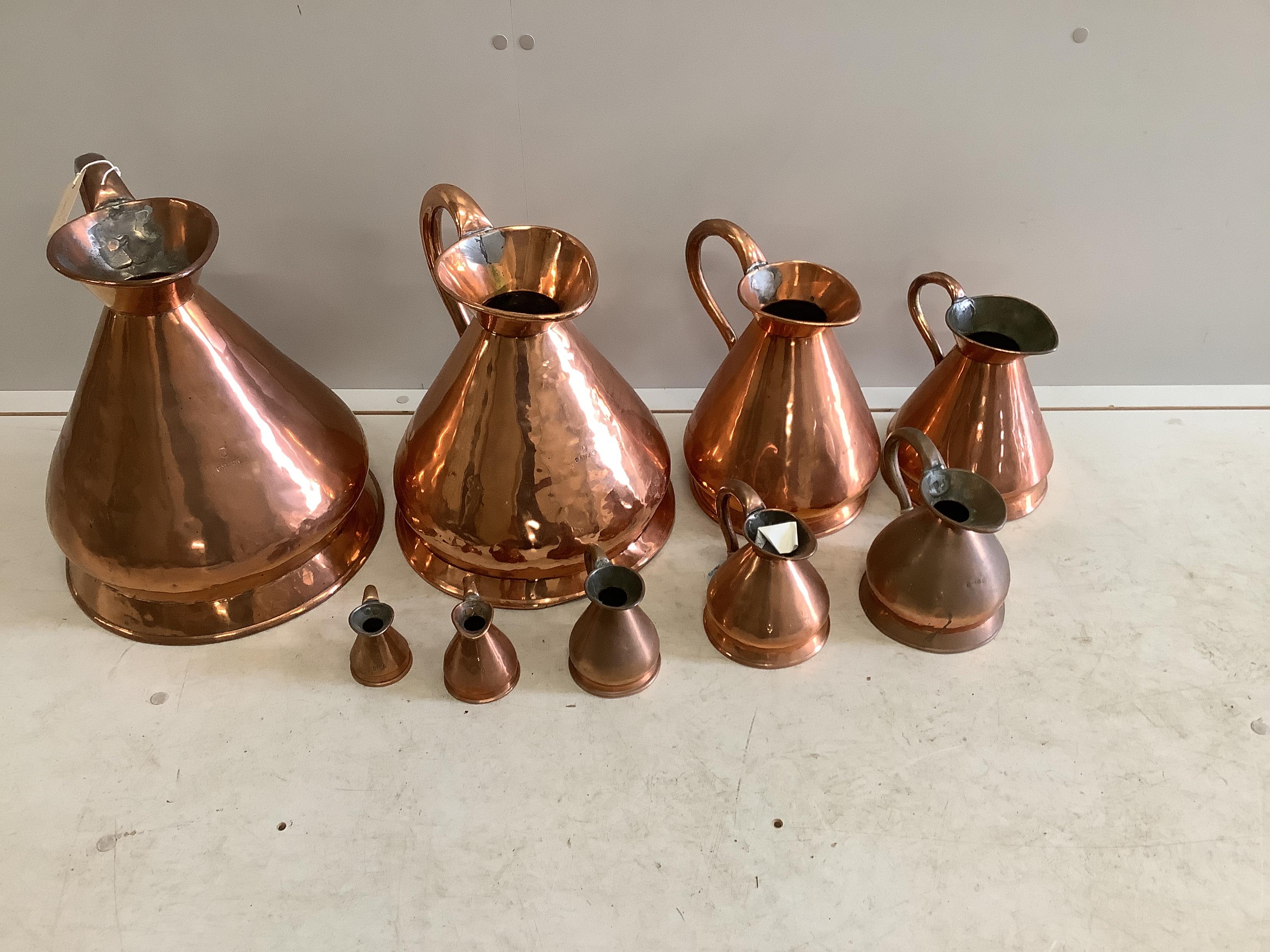 A matched graduated set of nine late 19th / early 20th century copper haystack measures, three gallons to half gill, largest height 39cm